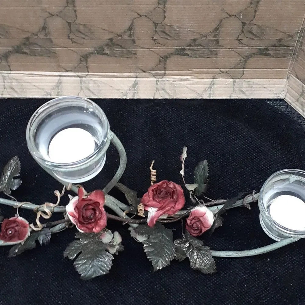 Long 3 candle black iron candle holder laced with trailing red roses.‎